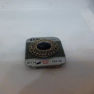 1928 black and silver brooch